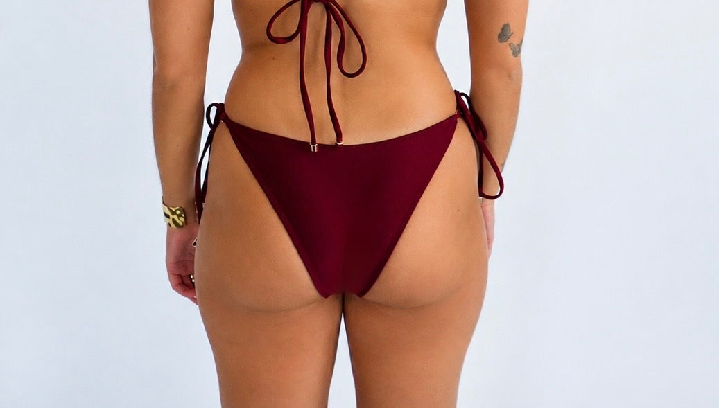 Burgundy triangle bikini bottom on a plain background
