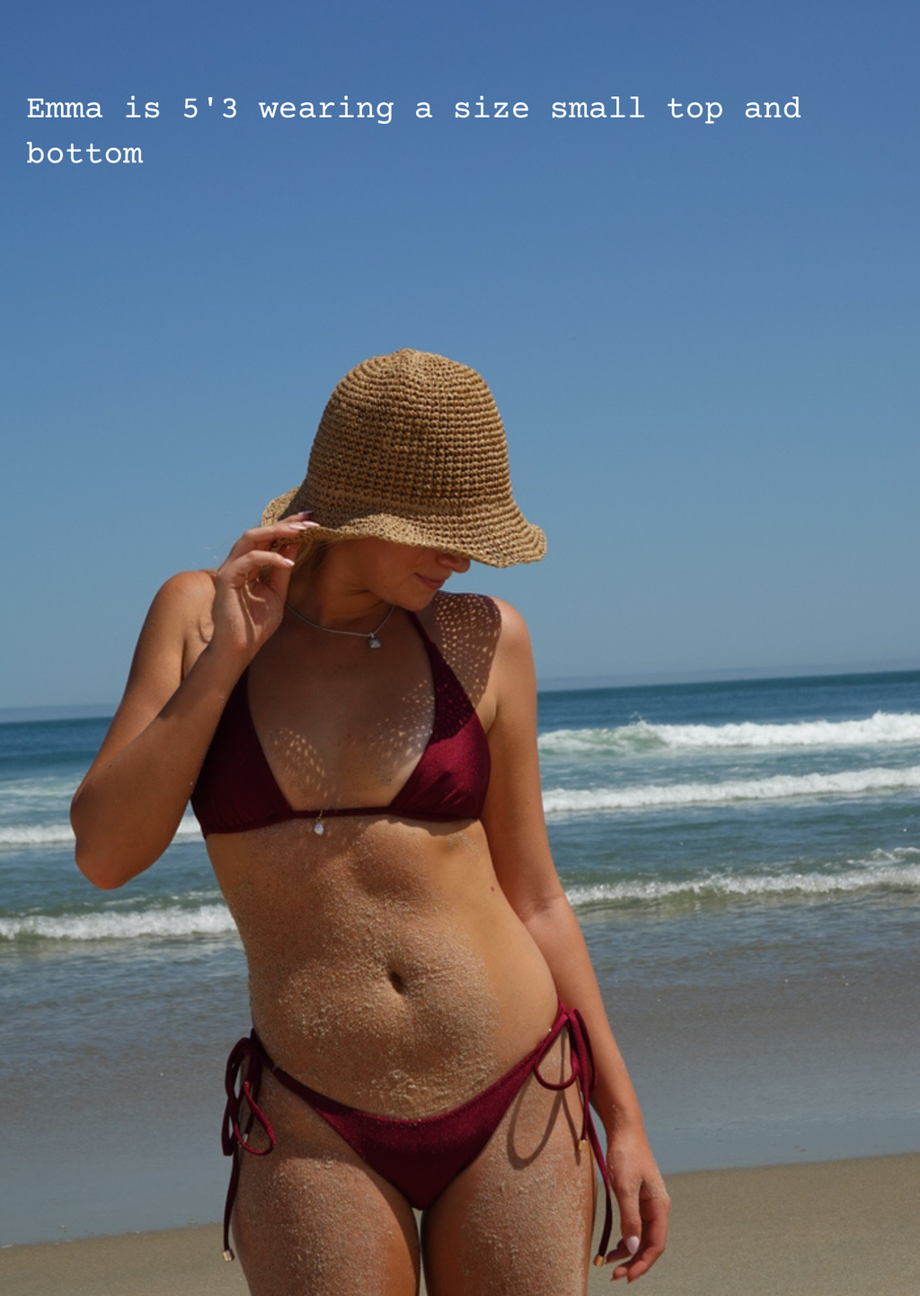 Woman in a red bikini and straw hat on a beach with text about height and clothing size.