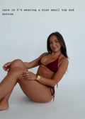 Woman wearing a red bikini sitting on a white background with text about height and size.